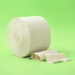 Roll of toilet paper on a green background