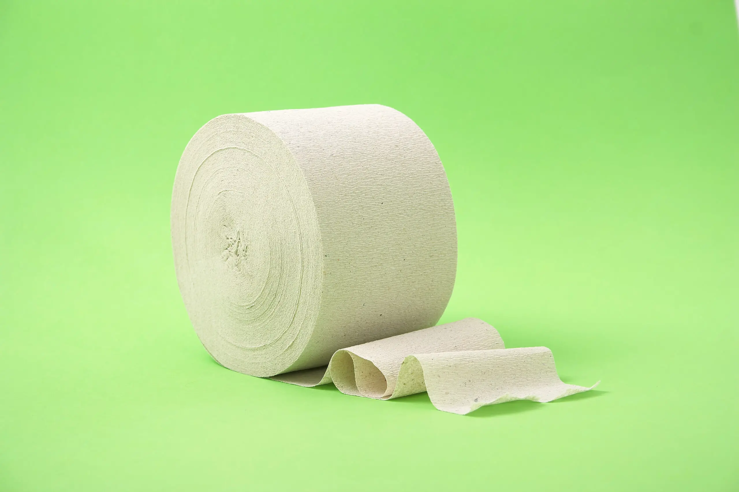 Roll of toilet paper on a green background