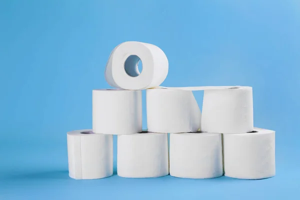 Rolls of toilet paper on light blue color background