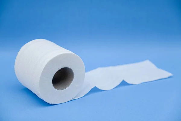 Toilet paper isolated on a blue background.