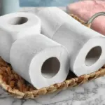 Wicker tray with toilet paper rolls on table