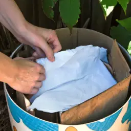 An image of a person composting used bamboo toilet paper in a backyard compost bin