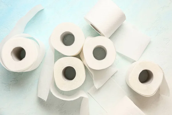 Rolls of toilet paper on light blue background