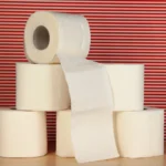 Rolls of toilet paper on striped red background