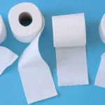 White toilet paper rolls on the blue background