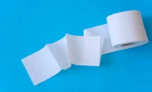 White toilet paper rolls on the blue background